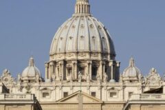 Front view of St. Peter's Basilica in Vatican City, featuring the grand dome and ornate façade.
